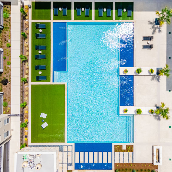 Aerial view of pool area with astroturf and lounge chairs