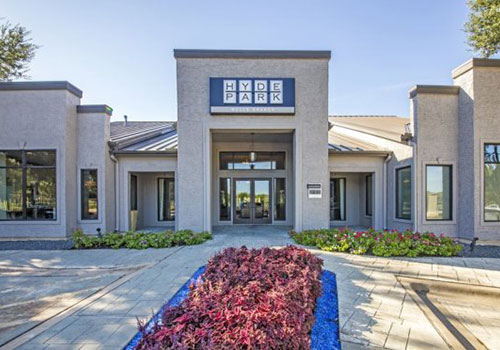 Modern clubhouse of Hyde Park complex with landscaping