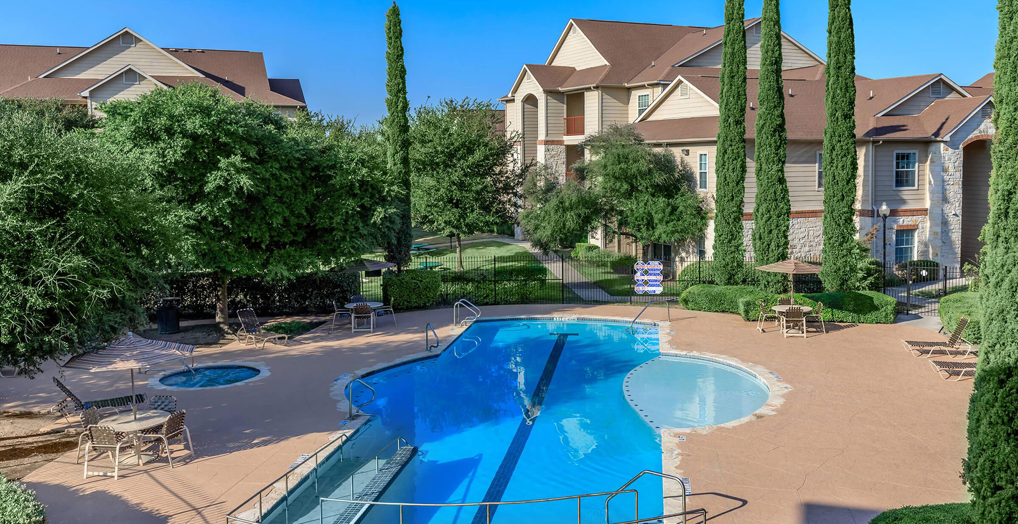 Pool area with hot tub at an affordable housing complex