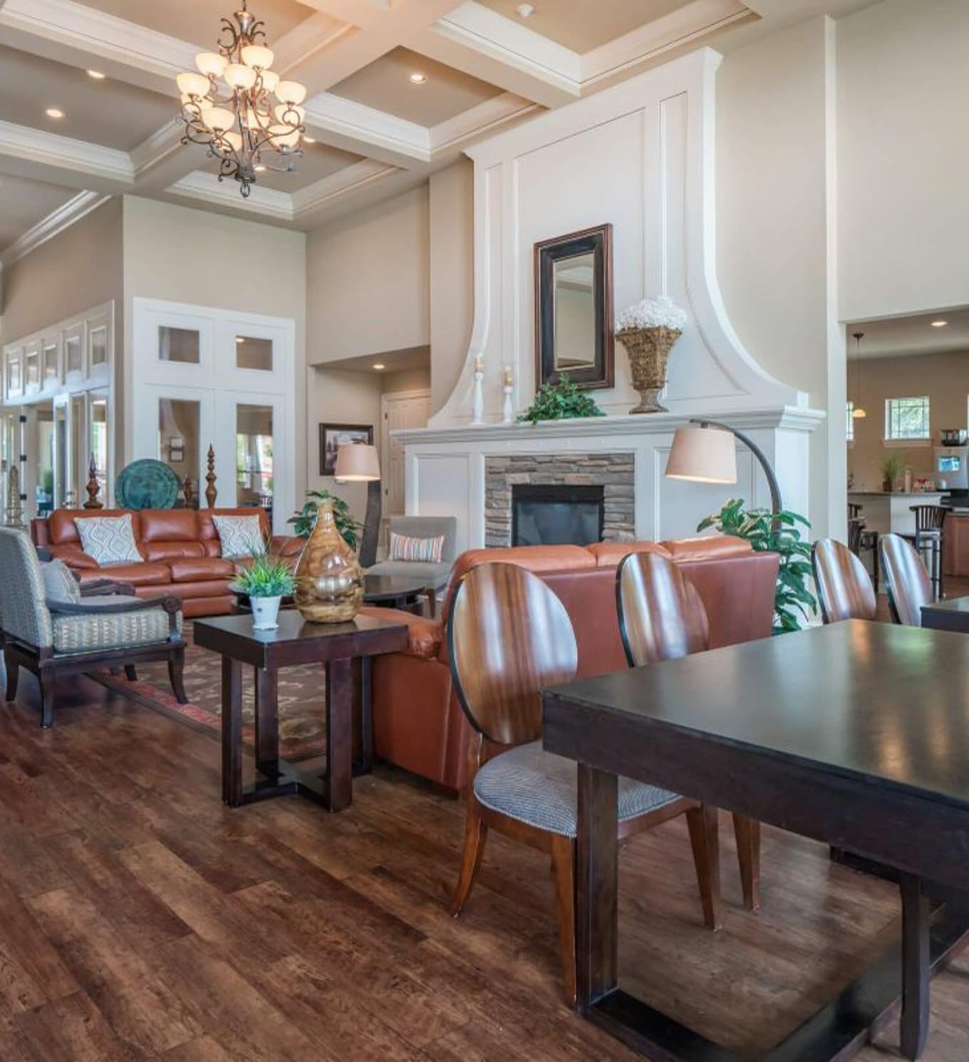 Upscale clubhouse with white paneling and leather couches