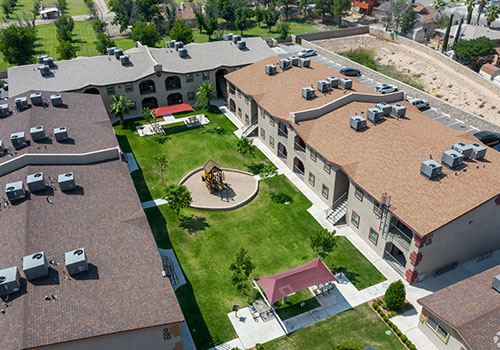 Apartment buildings surrounding a courtyard with playscape