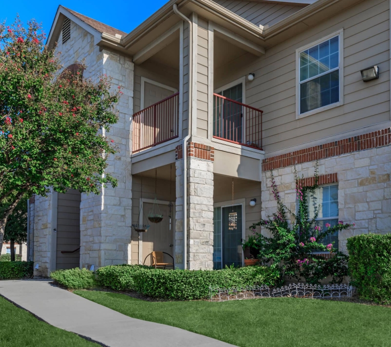 2-story limestone apartment building with brick accents